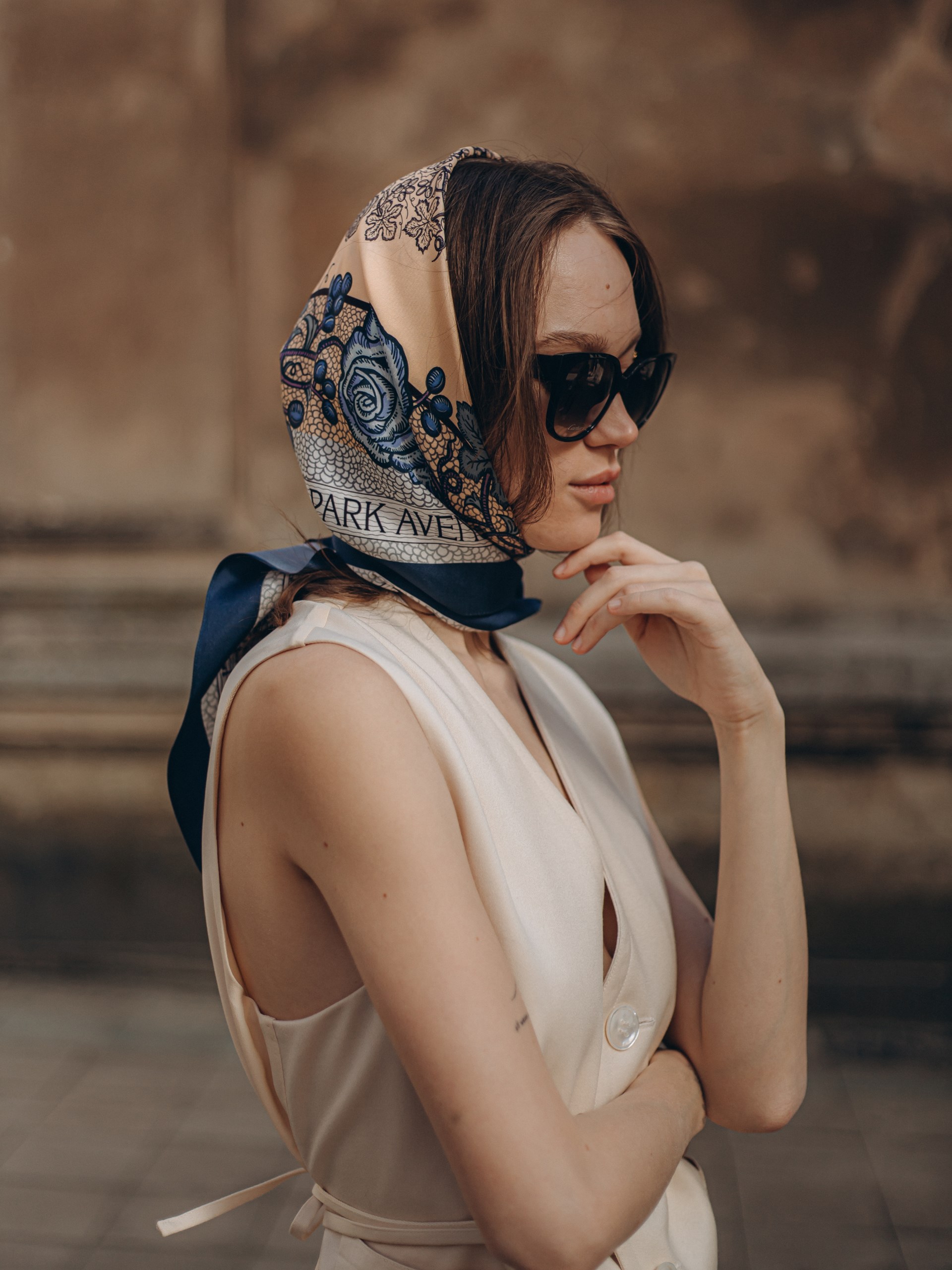 Park Avenue Atelier navy blue scarf on a beige background with an author's print