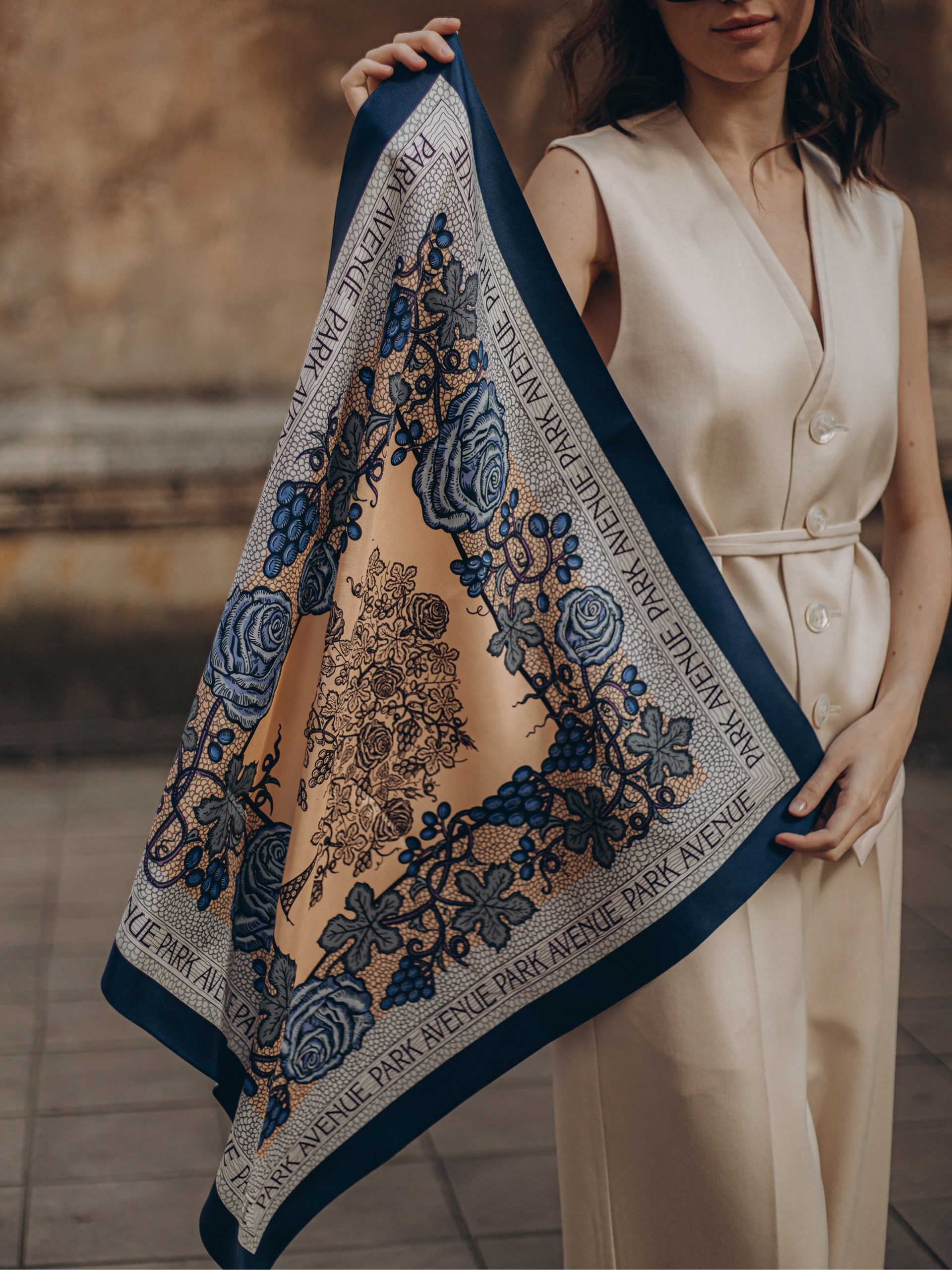 Park Avenue Atelier navy blue scarf on a beige background with an author's print