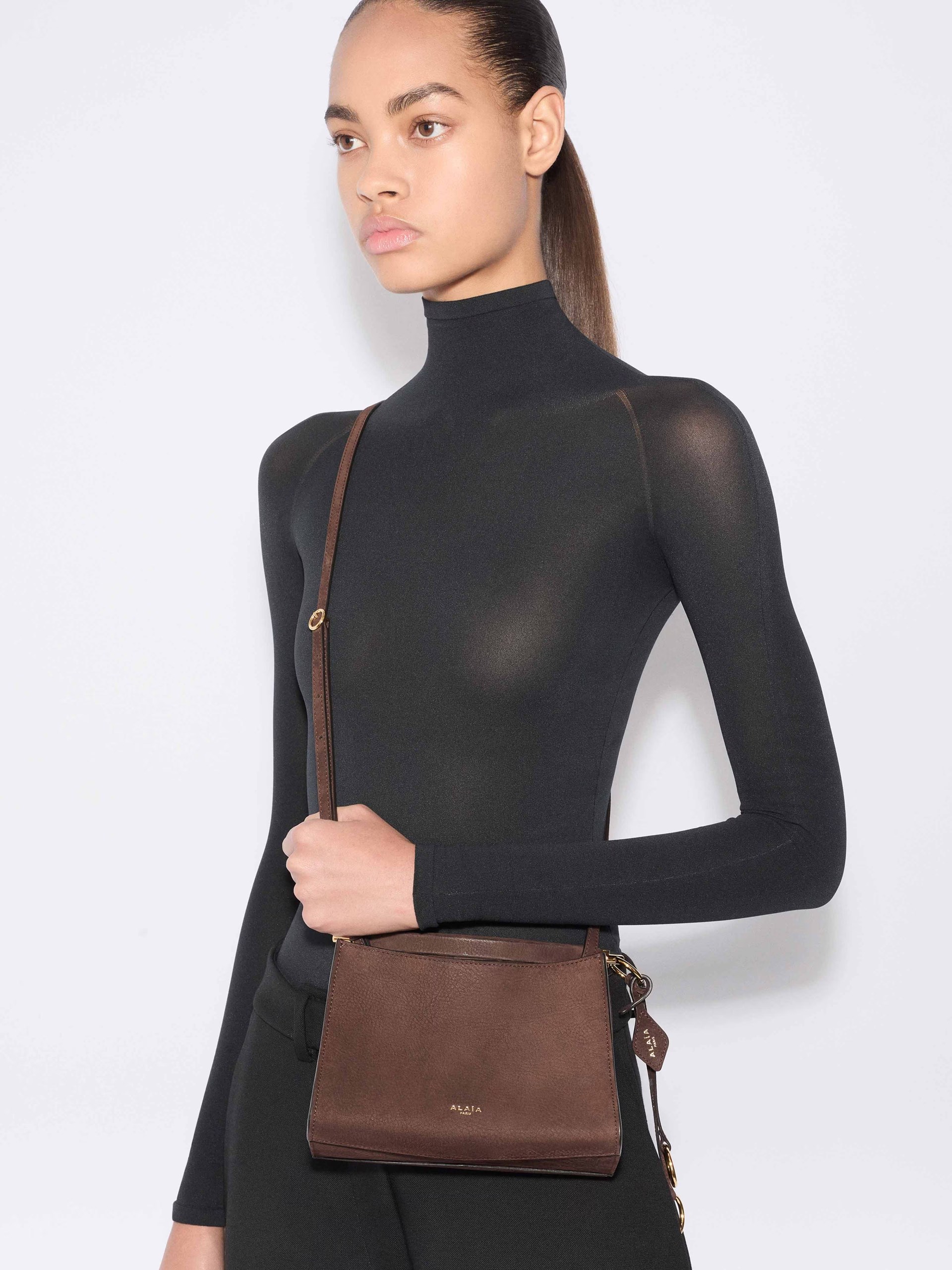 Dark brown Alaia Le Click bag with gold hardware