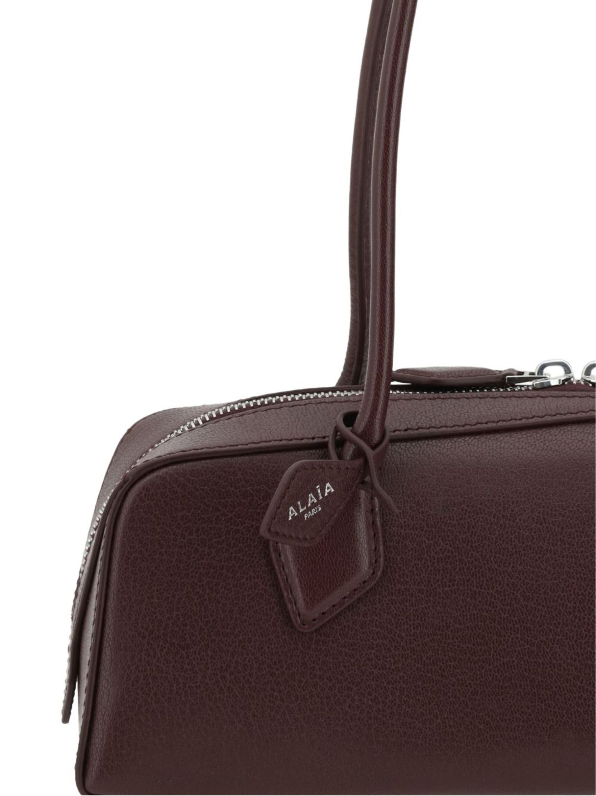 Alaia Le Teckel burgundy leather bag with elongated shape